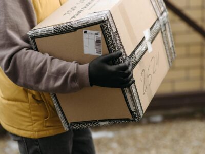 Mail Carrier Collecting Bulk‑Stamped Letters from Box